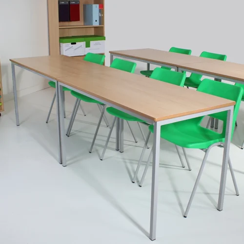 Green Chairs at Wooden Classroom Tables