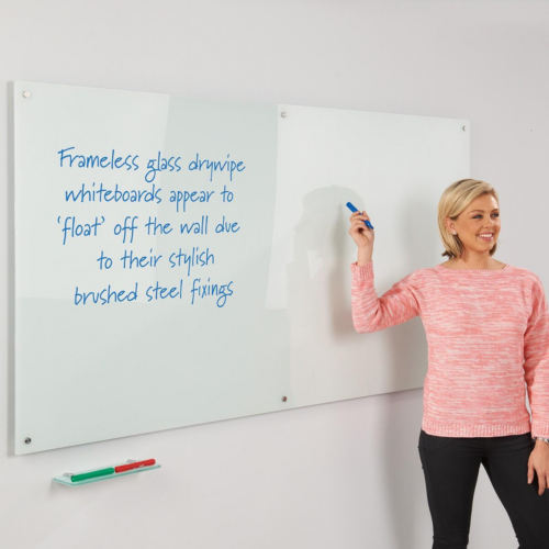 Woman standing next to WriteOn Glass Magnetic Board