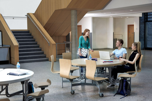 Students sitting at Round Primo Mobile Folding Dining Unit